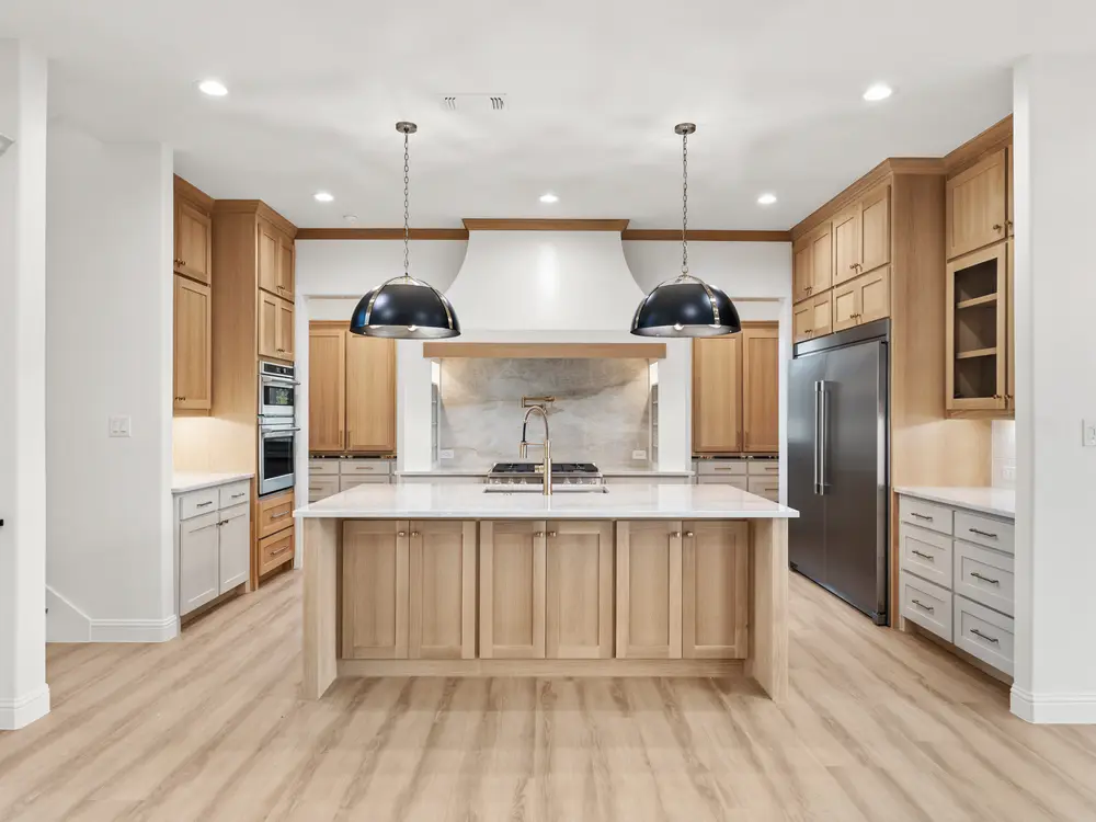 White kitchen with island pendants