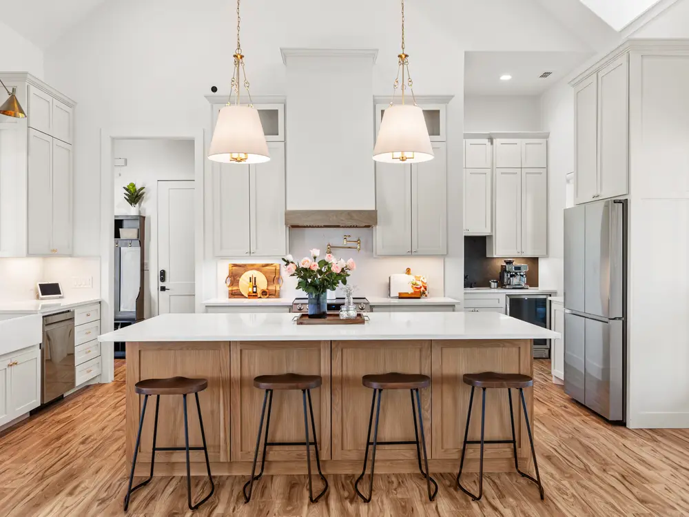 Kitchen with brass pendants and island