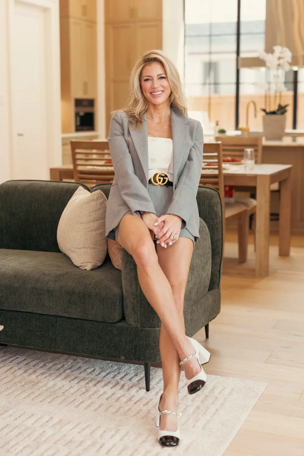 Agent in a gray blazer seated in a bright living room